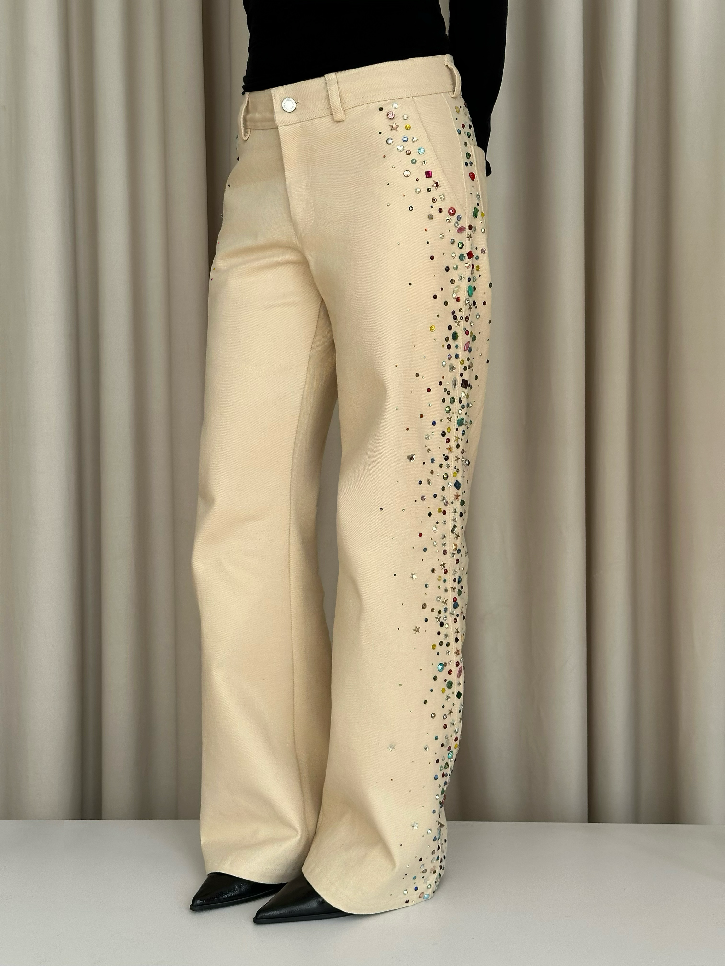 Beige jeans with colorful embellishments