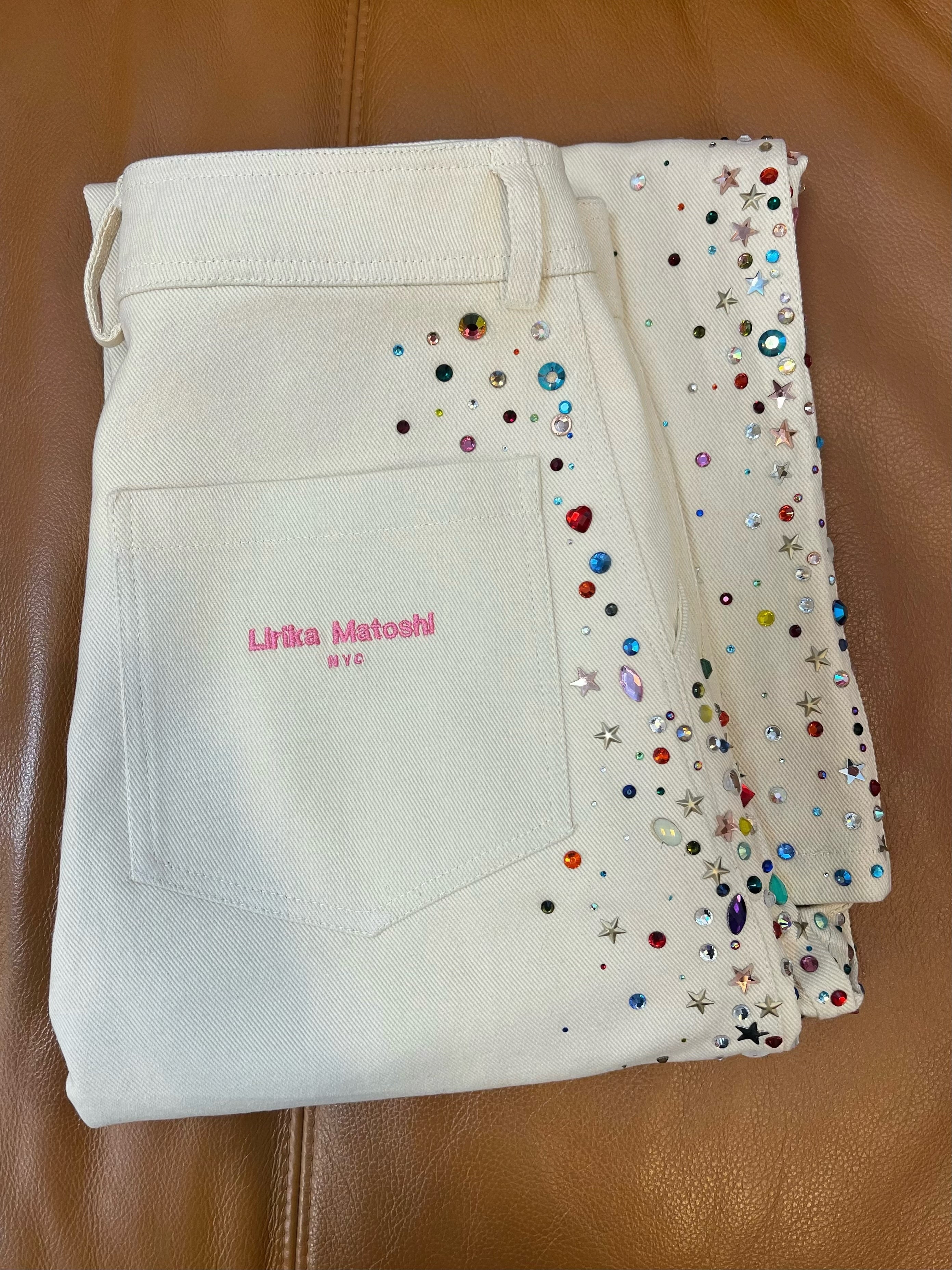 Beige jeans with colorful embellishments