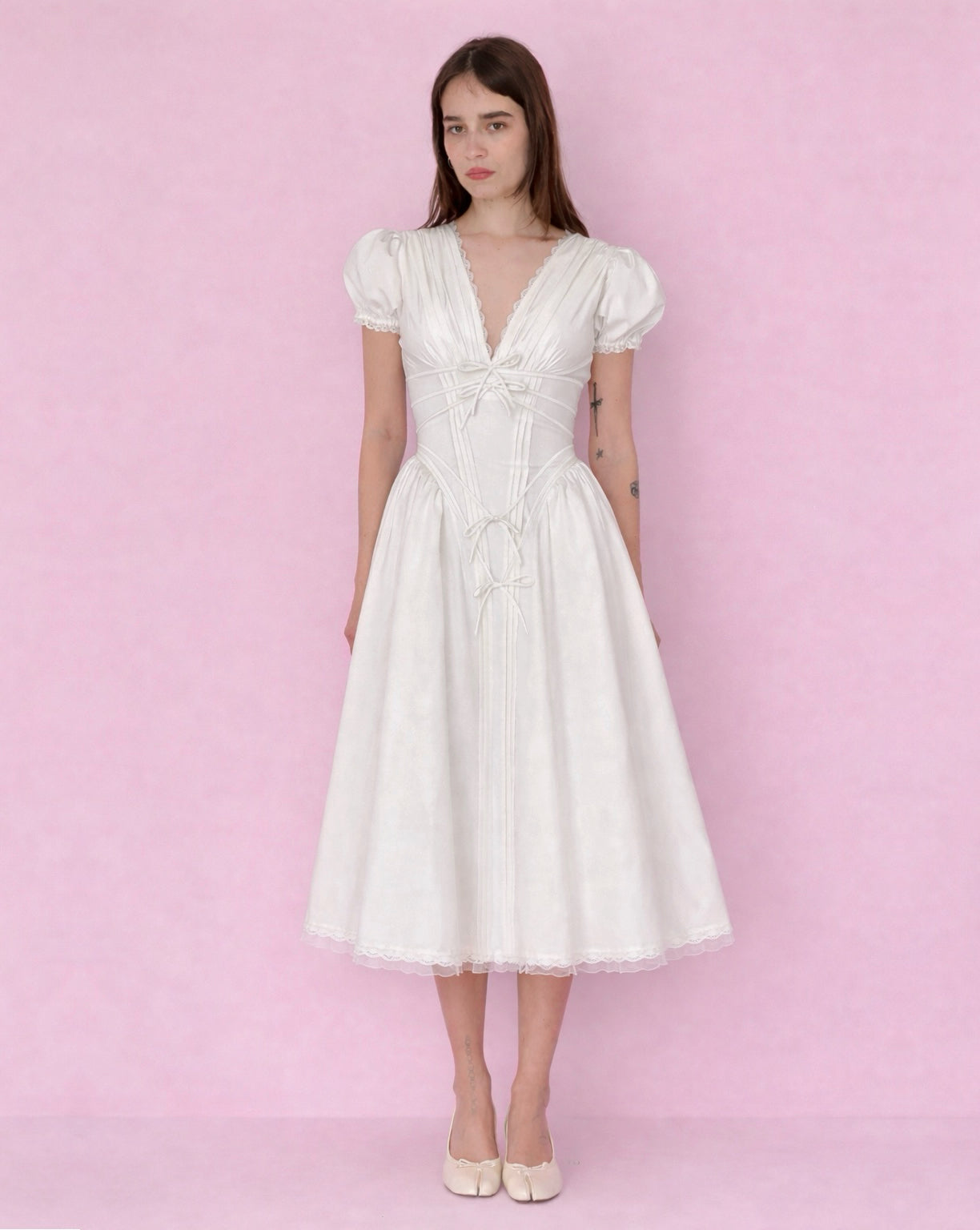 White midi A-Line dress with short puff sleeves, v-neck and embroidered bows