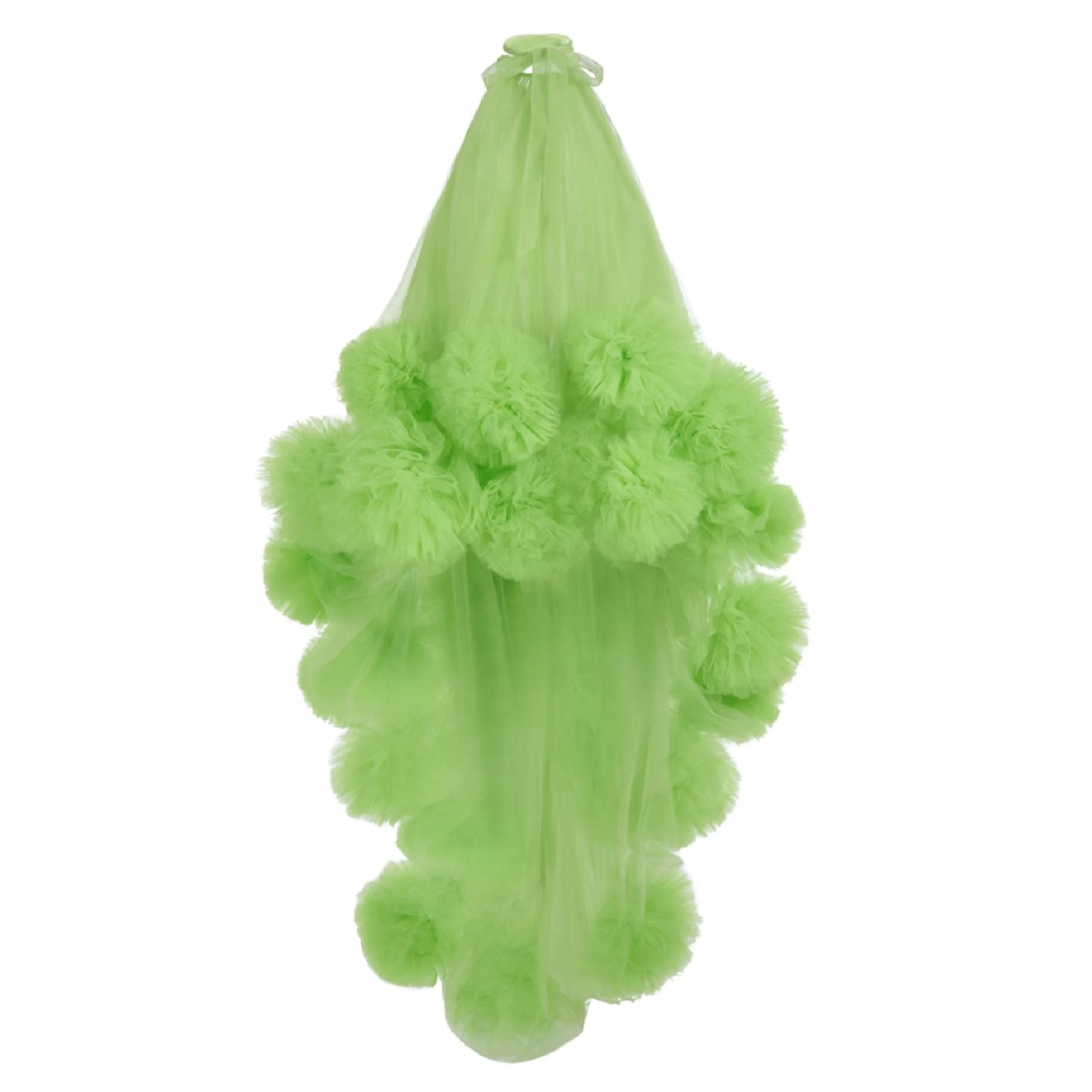 A green dress with a tulle fabric and voluminous skirt hanging against a white background.