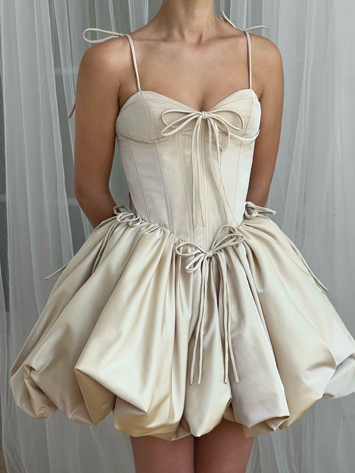 Beige mini dress with a corset-style bodice and balloon skirt