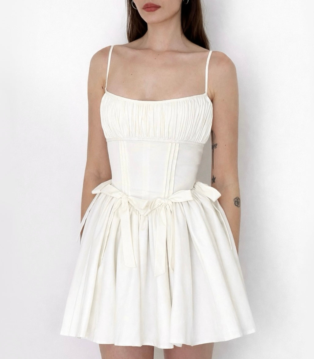 White mini dress with straps and embroidered bows