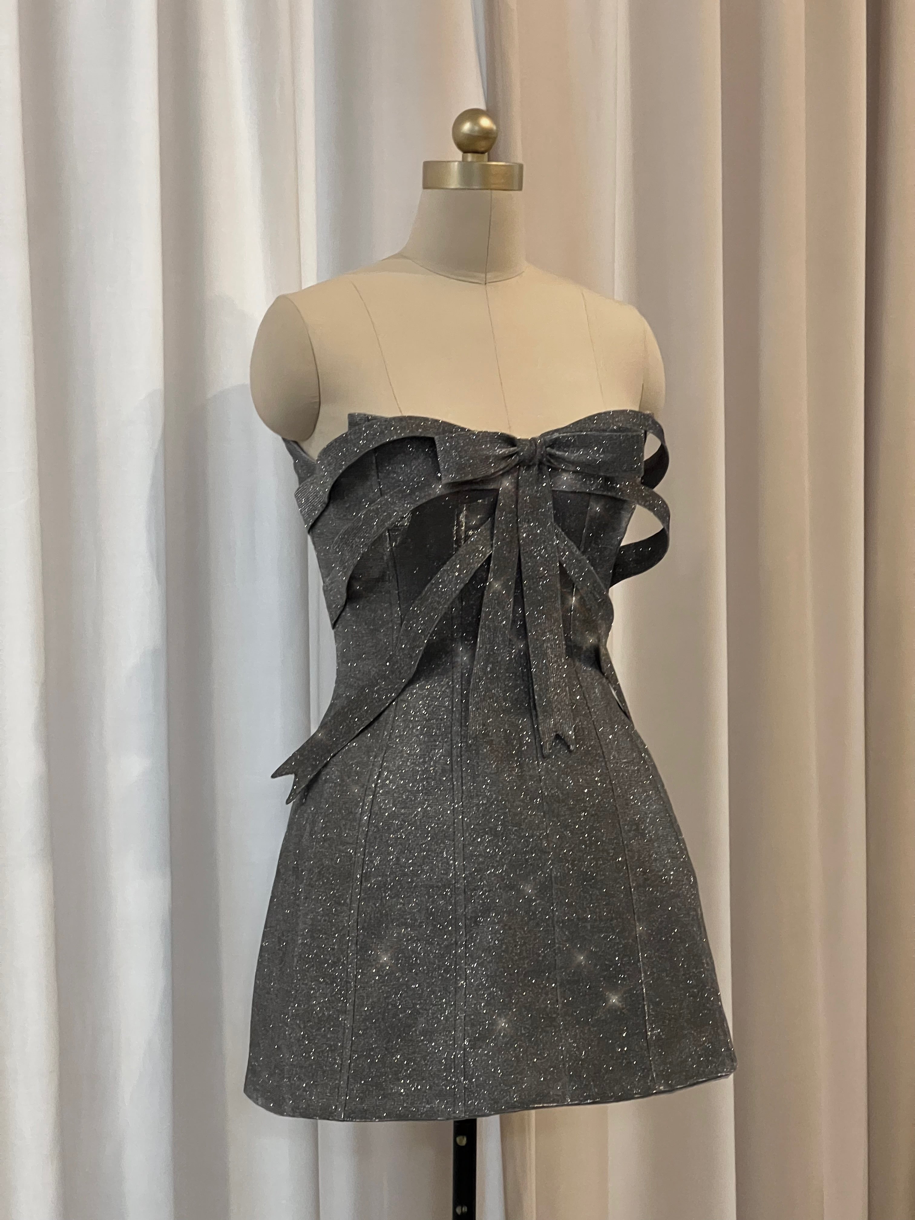 Gray dress with a large bow and sparkles