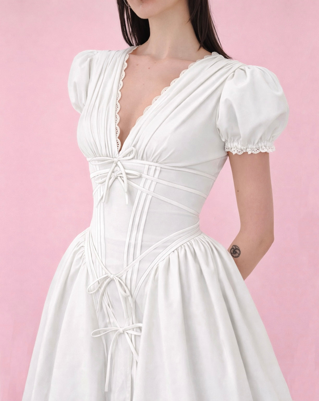 White mini A-Line dress with short puff sleeves, v-neck and embroidered bows