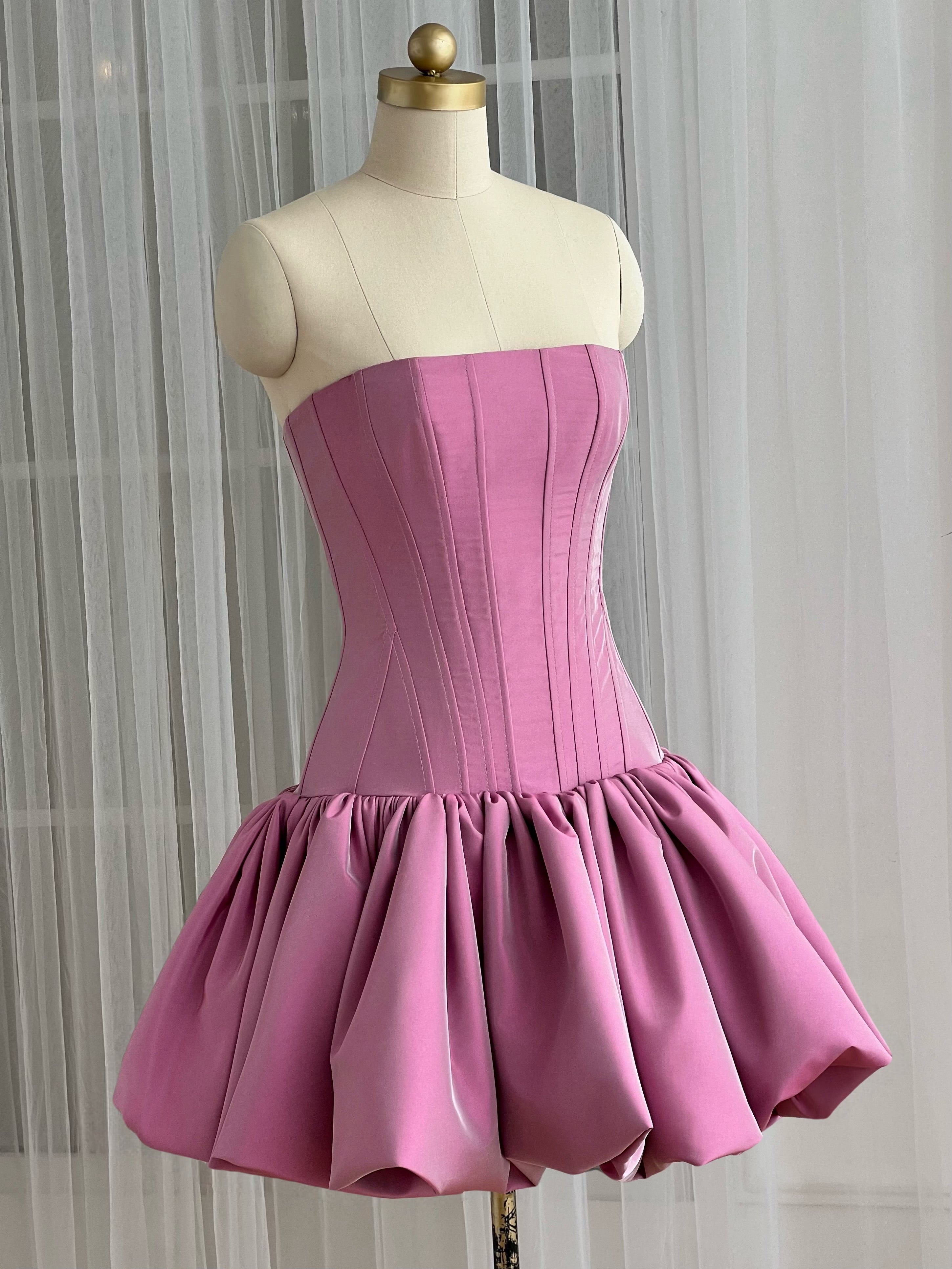 Pink strapless mini dress with a fitted bodice and flared skirt
