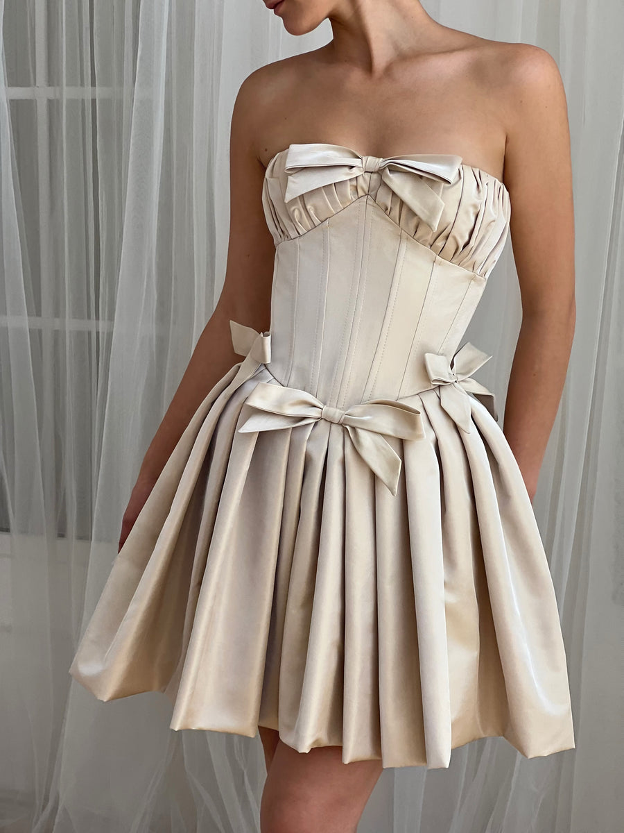 Beige strapless dress with large bow detail
