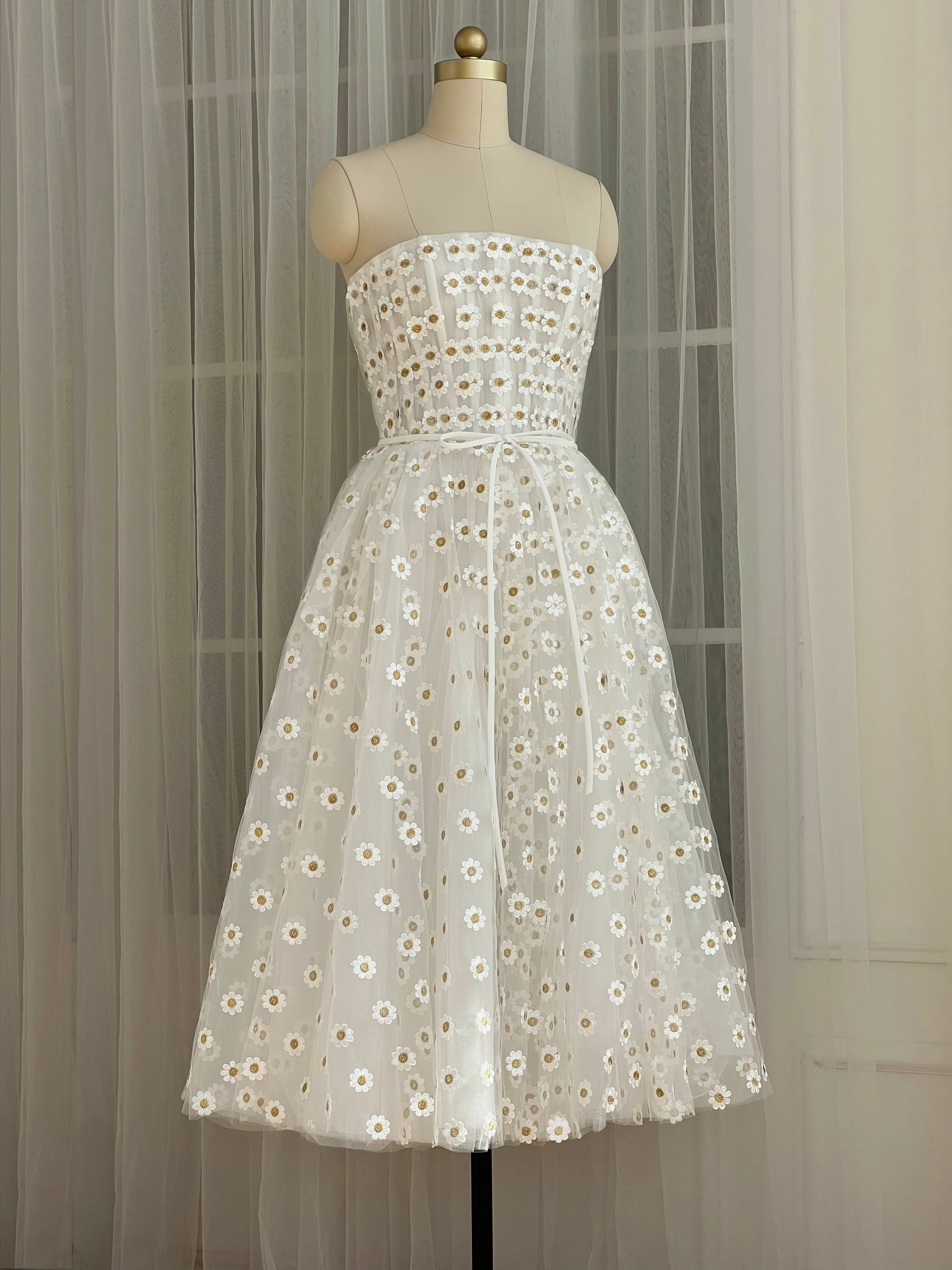 White midi dress with embroidered daisies and no sleeves