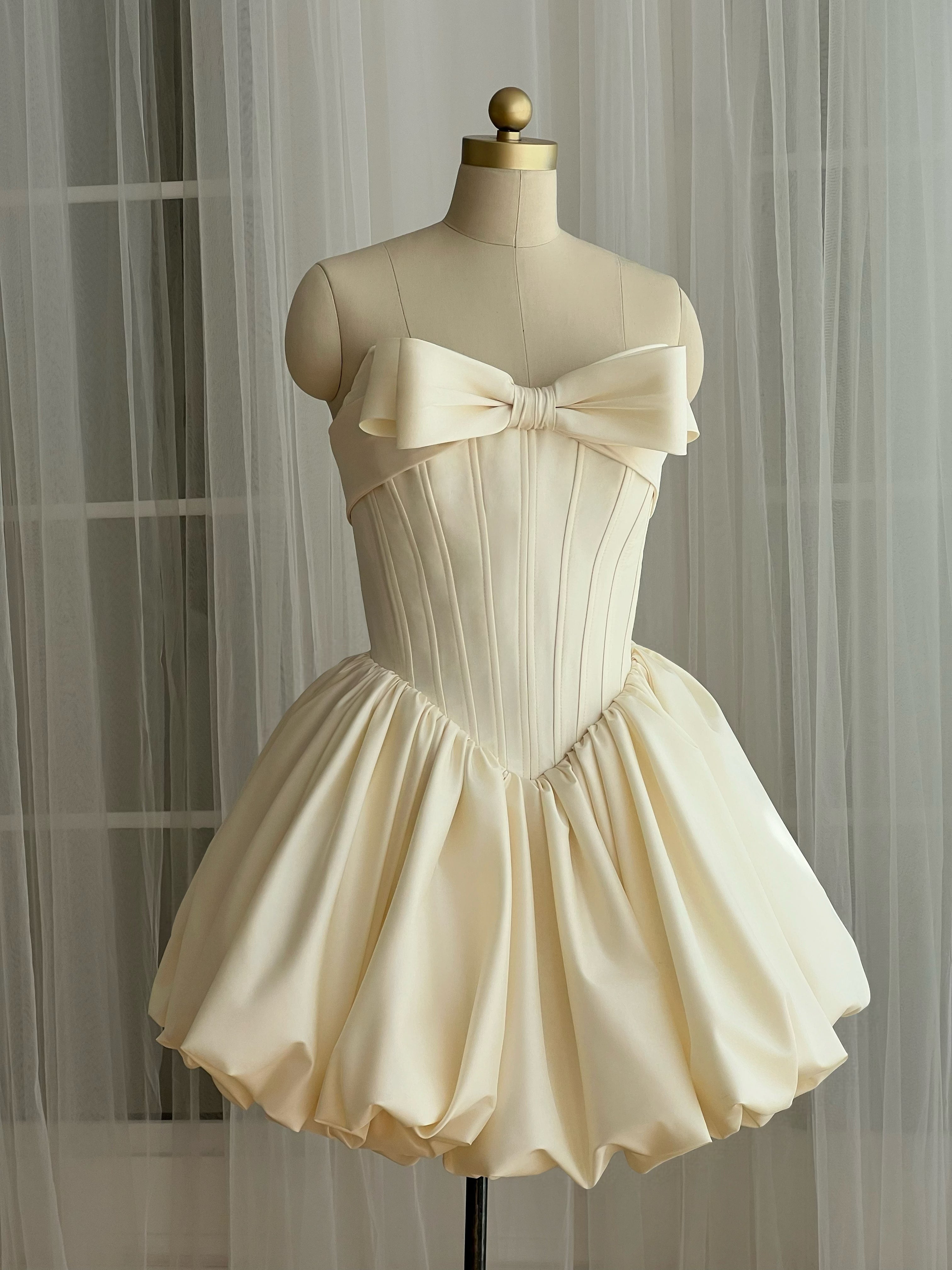 ivory mini dress with an embroidered bow detail