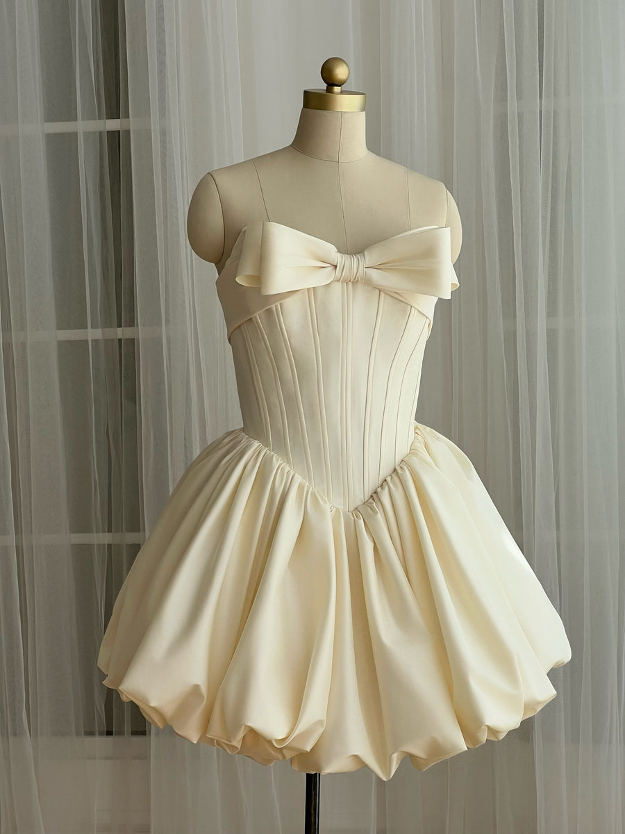 White mini dress with an embroidered bow detail