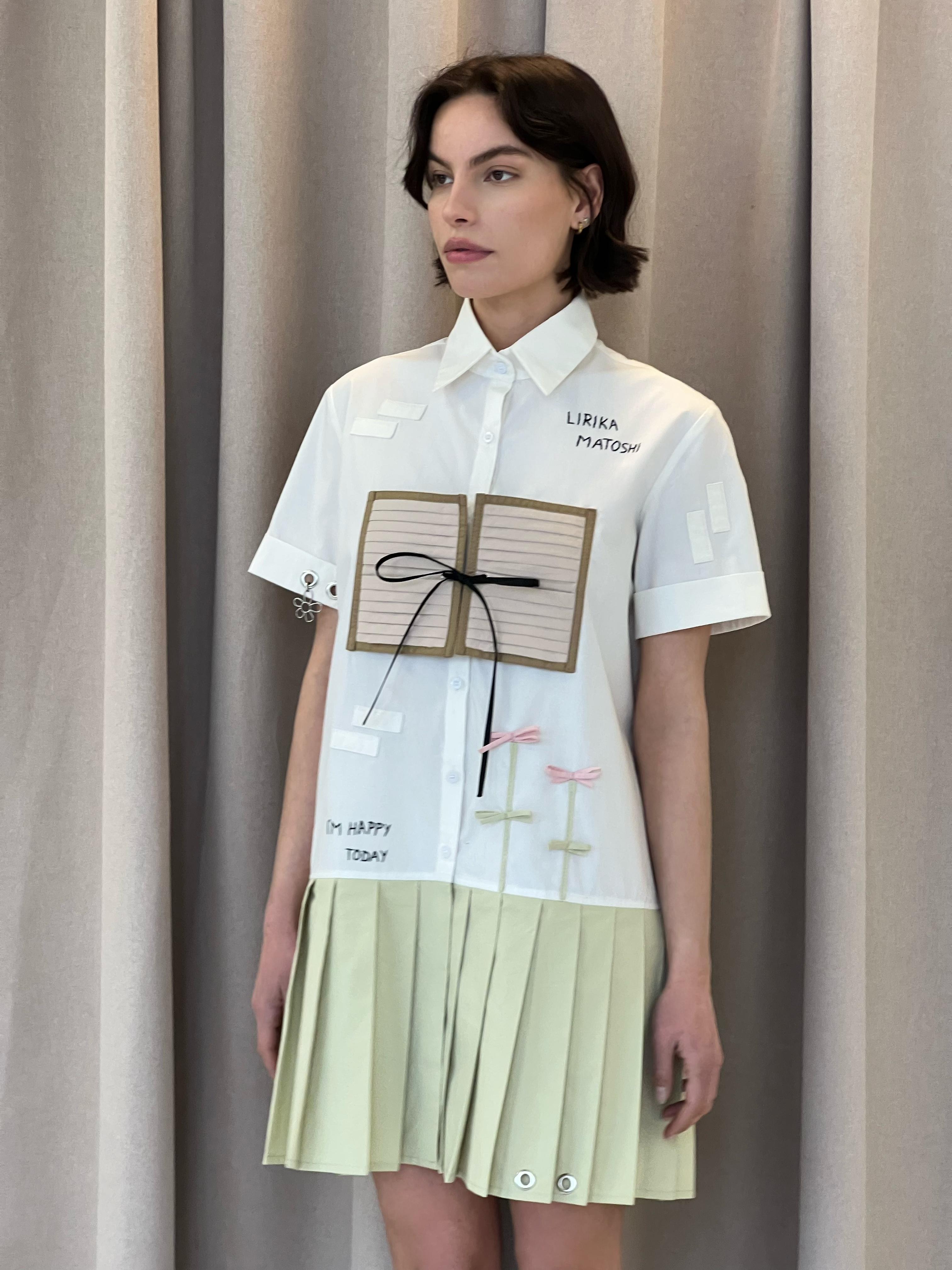 mini white and beige dress with embroidered figures