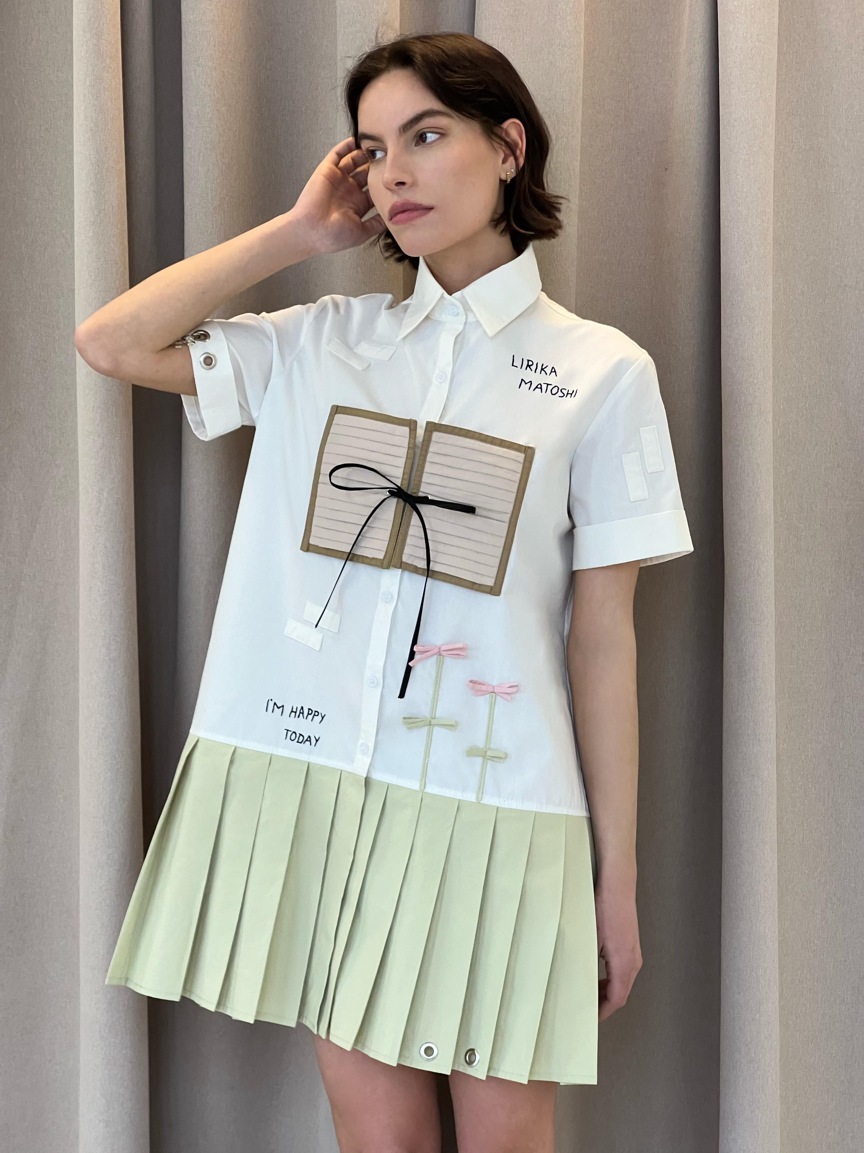 mini white and beige dress with embroidered figures