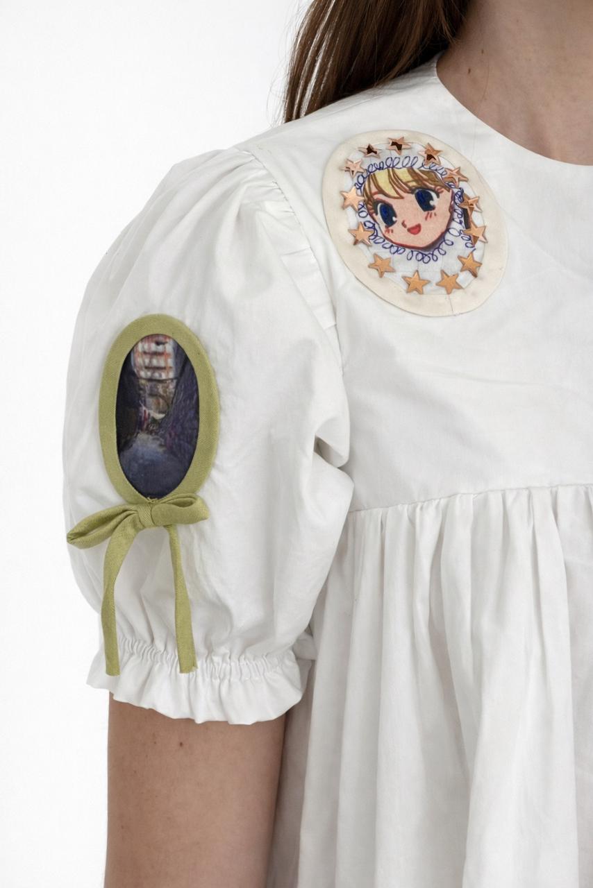 White mini dress with short sleeves and embroidered picture frames