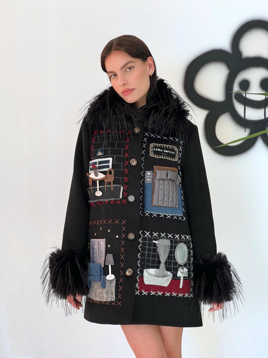 Black wool coat with apartment like embroidered figures and black faux fur