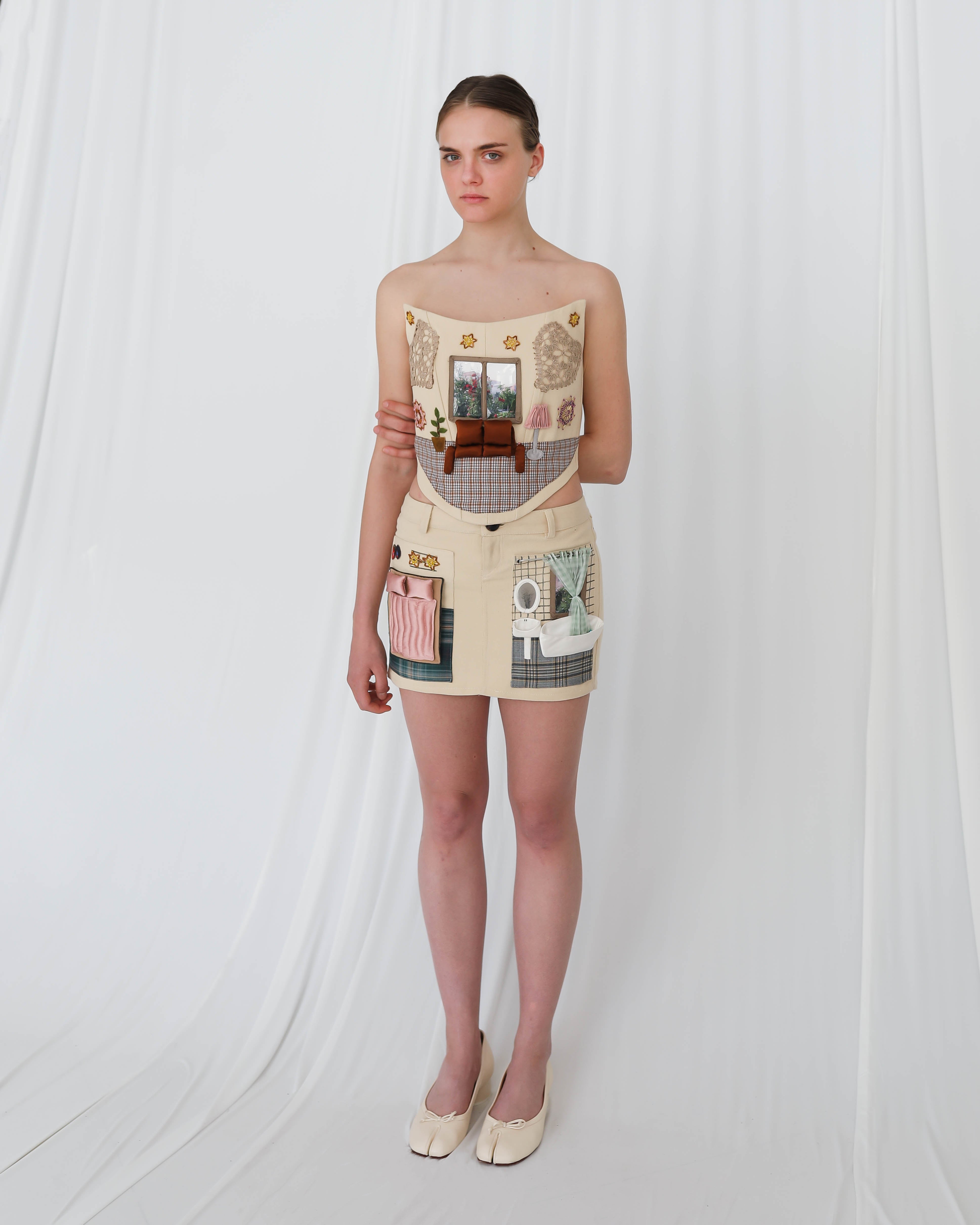 corset and skirt with apartment like figures and furniture, hand made and embroidered