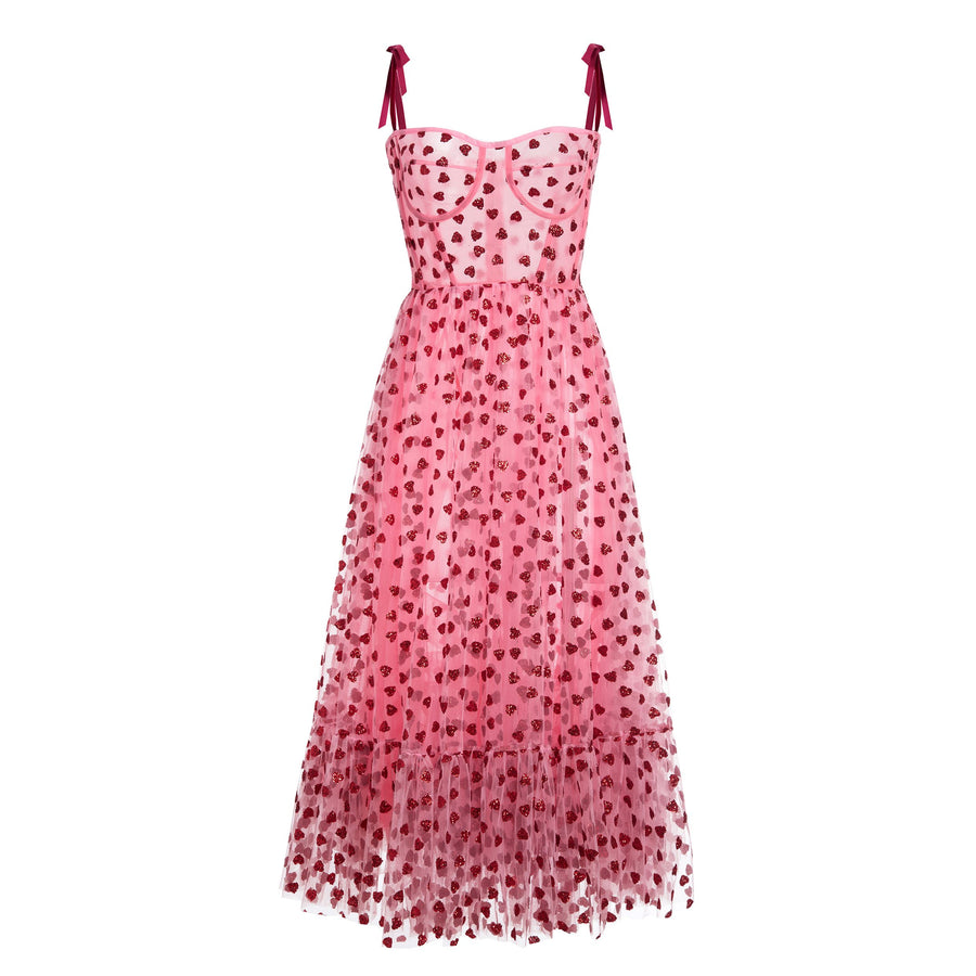 A pink midi dress with glittery heart details and ribbon tie straps.
